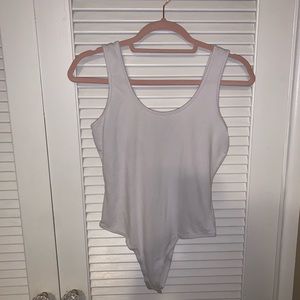 One white body suit tank top and a black one.